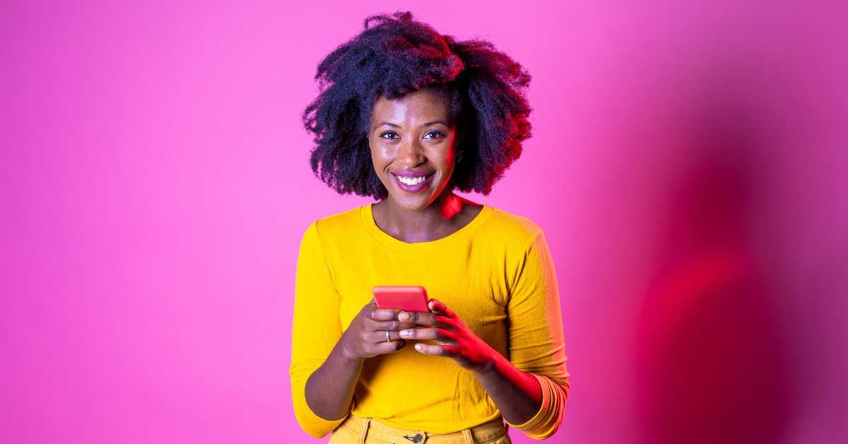 a woman smiling while texting